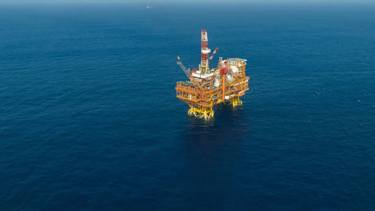 Plateforme pétrolière jackup isolée sur une mer bleue calme.