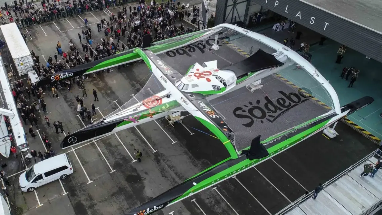 Le bateau de Thomas Coville, un trimaran Sodebo, est prêt pour une nouvelle aventure. Une foule nombreuse est rassemblée pour le départ.