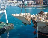 Démantèlement du Costa Concordia : une section du navire est soulevée par une grue dans un port.