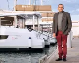 Olivier Poncin, PDG de Catana Group, pose devant des catamarans Bali 4.8.
