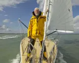 Robin Knox-Johnston, le légendaire navigateur, sur son voilier, prêt pour une nouvelle aventure en mer.