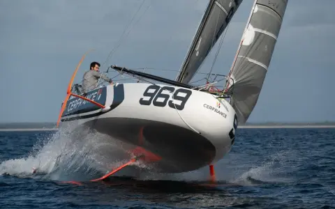 Voilier Pogo 6.50 "Cerfrance" #969 fend les vagues, le skipper concentré.